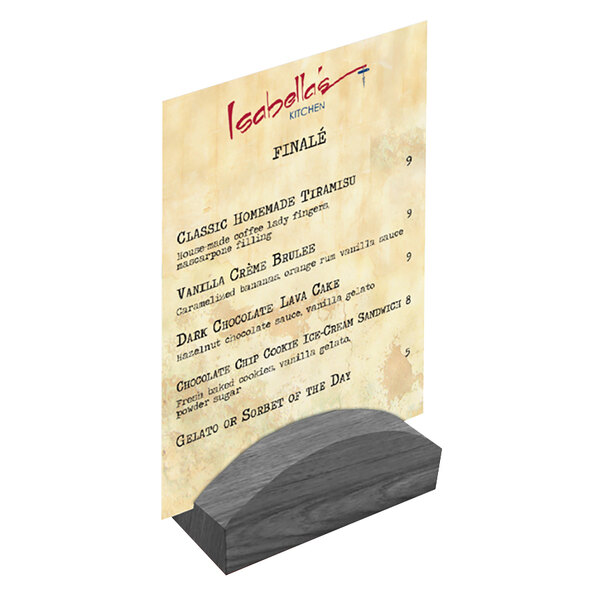 A Menu Solutions ash wood rounded card holder on a table with a menu.