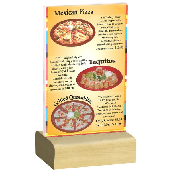 A Menu Solutions clear acrylic table tent with a natural wood base on a table with a pizza and tacos.