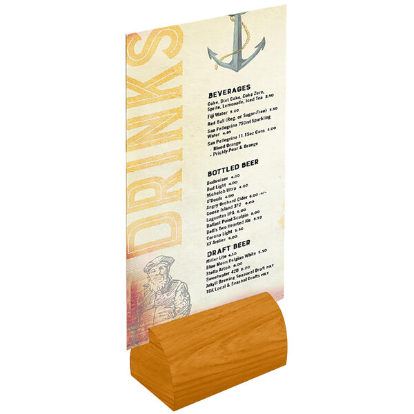 A Menu Solutions country oak wood curved card holder with a menu in it on a table.