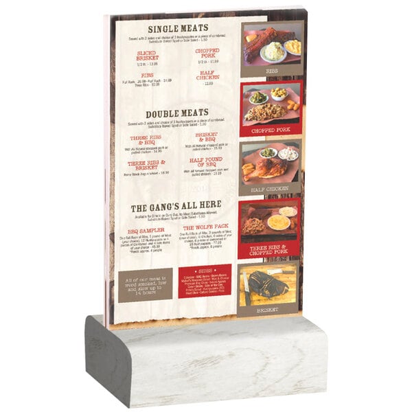 A Menu Solutions clear acrylic table tent with a solid white wash wood base holding a menu on a table with a white tablecloth.