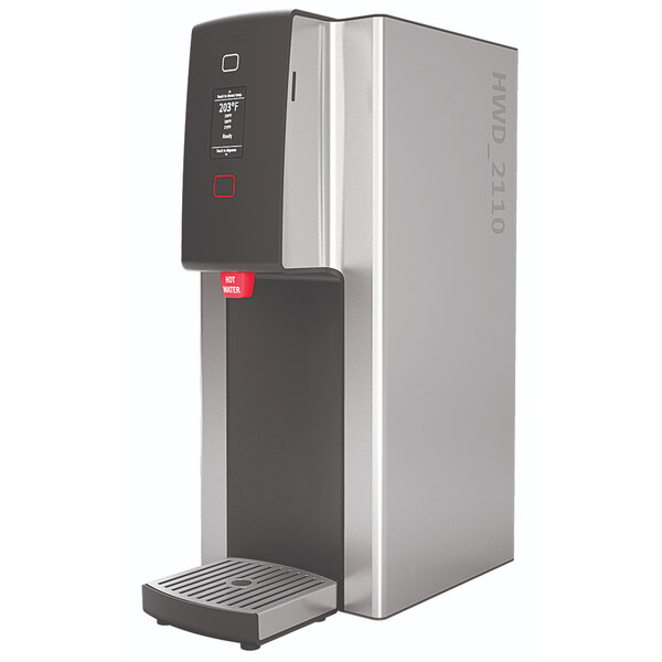 A stainless steel Fetco hot water dispenser with black and red push-button controls.