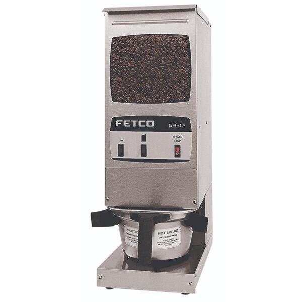 A silver and black Fetco commercial coffee grinder with a coffee bean on top.
