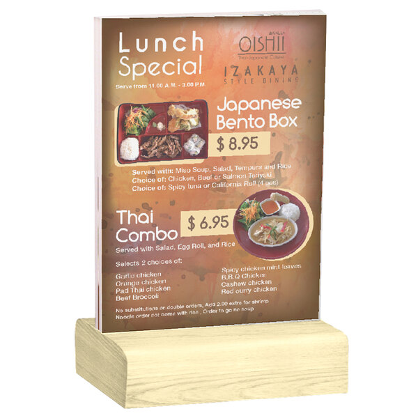 A Menu Solutions clear acrylic table tent on a natural wood stand holding a menu.