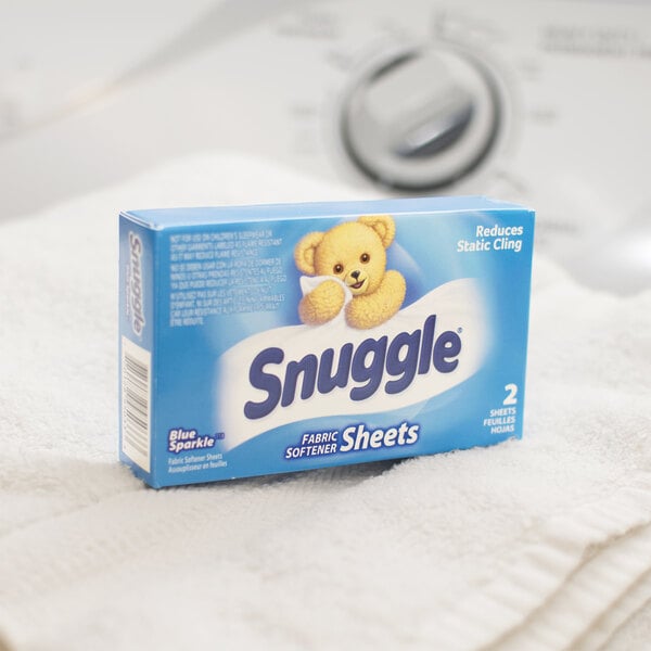 A box of Snuggle fabric softener sheets on a white towel.