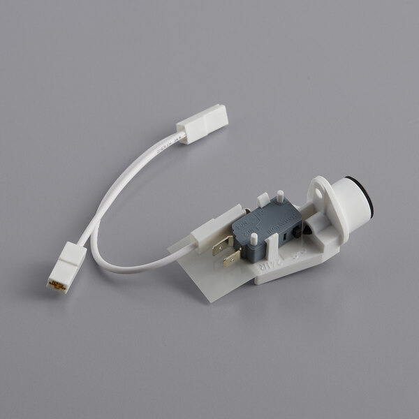 A white and grey electrical microswitch with a wire.