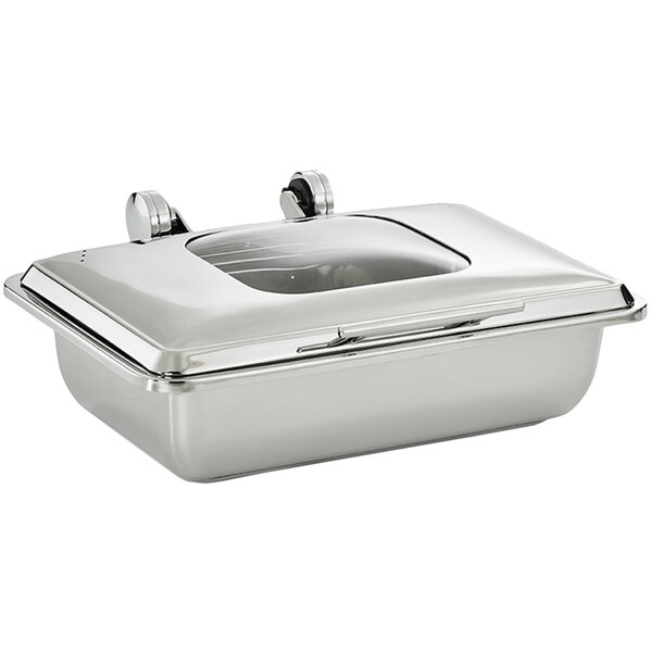 A Vollrath stainless steel chafer with a glass lid on a counter.