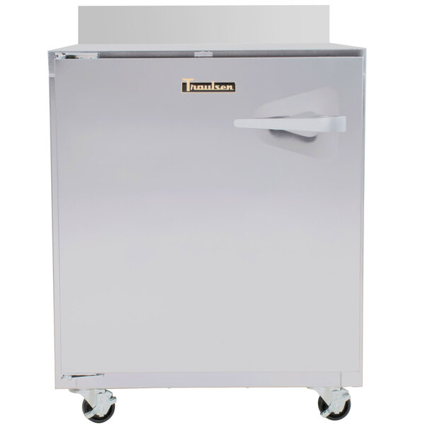 A Traulsen stainless steel worktop refrigerator with a handle and wheels.