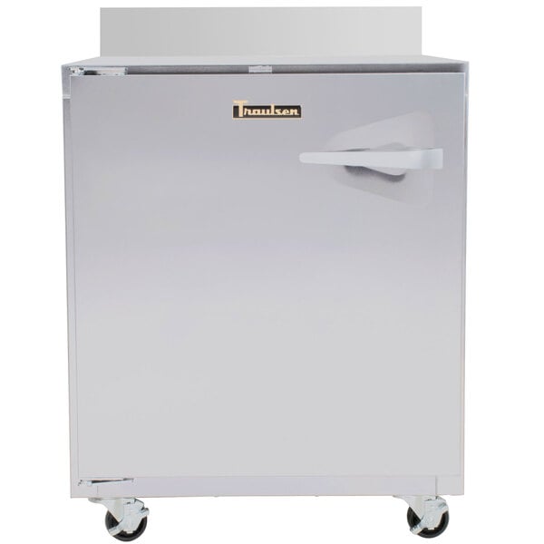 A Traulsen stainless steel worktop refrigerator with a wheel on the bottom.