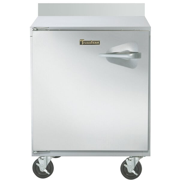 A Traulsen stainless steel worktop freezer with a door and wheels.