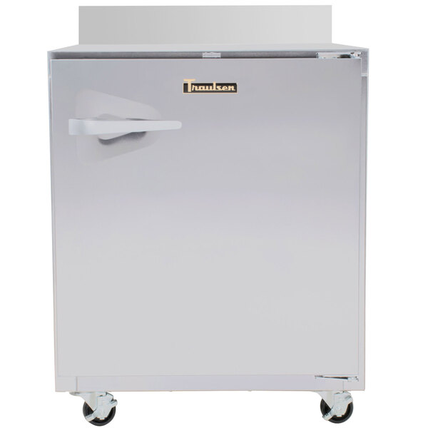 A Traulsen stainless steel worktop refrigerator with a door on wheels.