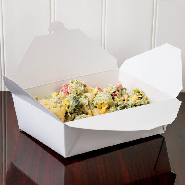 A white Fold-Pak Bio-Pak take-out box filled with food on a table.
