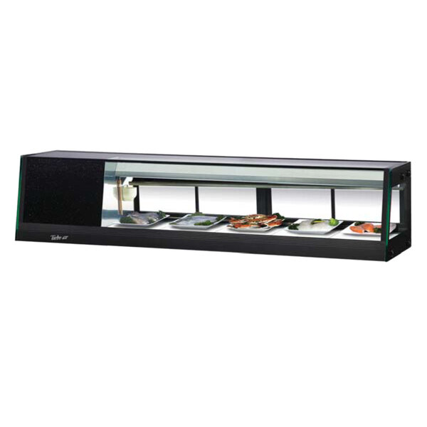A Turbo Air black and white refrigerated sushi case with food displayed inside.