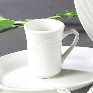 A CAC Garden State bone white porcelain coffee mug with a white handle on a white saucer.