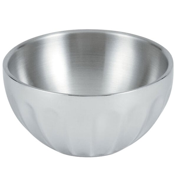 A silver Vollrath double wall fluted bowl with a curved edge.