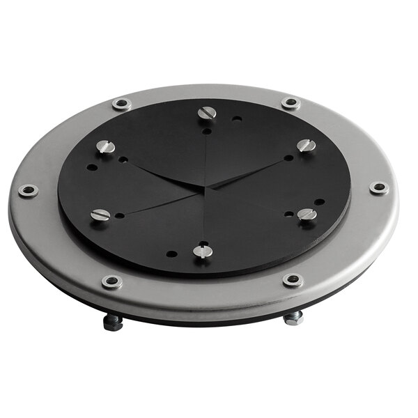A black and silver circular plate with screws and a black circle.