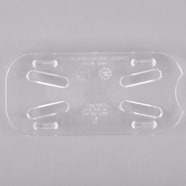 A clear plastic Cambro drain tray with four holes.