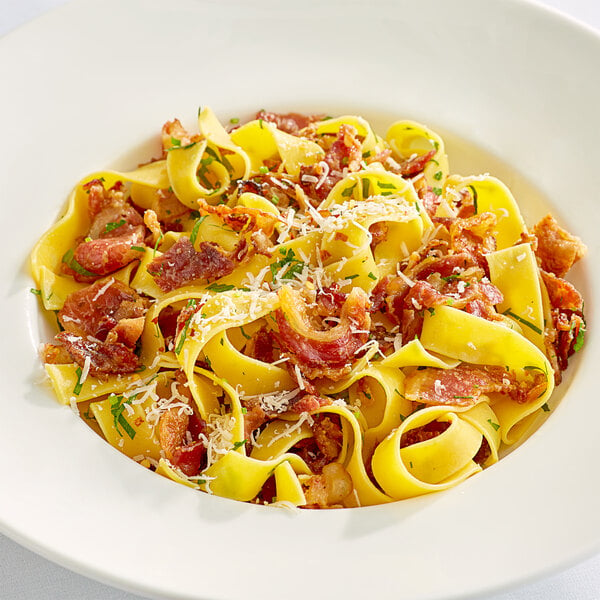 A white plate of pasta with Hatfield bacon.