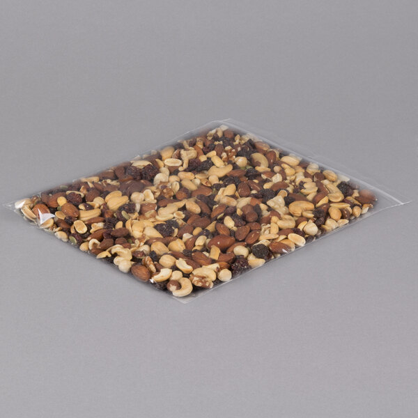 A close-up of a LK Packaging plastic food bag filled with nuts on a gray background.