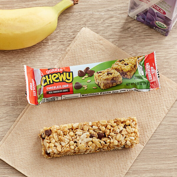 A Quaker Chewy Chocolate Chip Granola Bar next to a banana on a table.