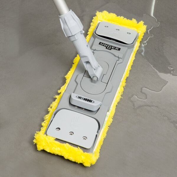 A Unger SmartColor yellow wet/dry mop pad attached to a handle.