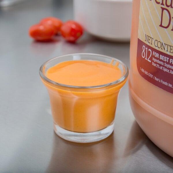 A bottle of Ken's Foods Deluxe French Dressing on a counter.