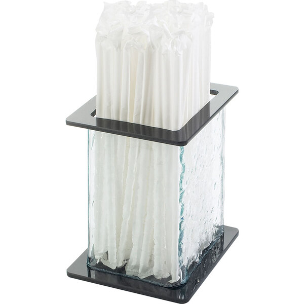 A Cal-Mil glass straw holder with white straws in it.