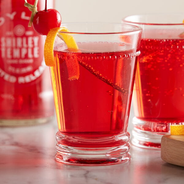 A pair of glasses with Boylan Shirley Temple soda and a cherry on top.