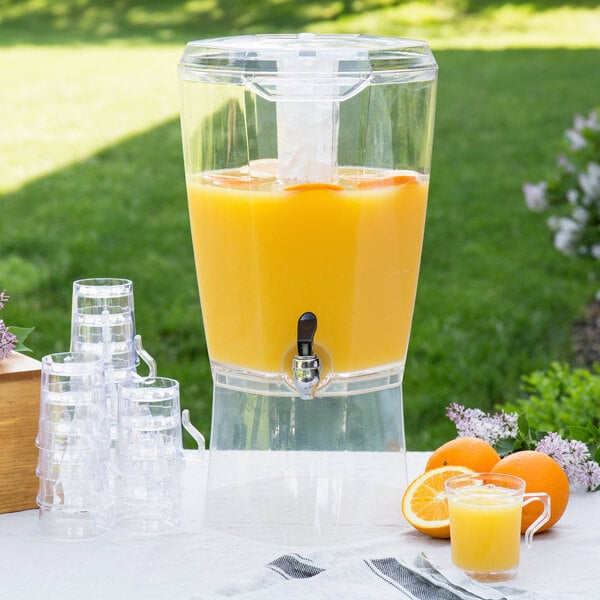 A close-up of the Choice acrylic beverage dispenser filled with orange juice.