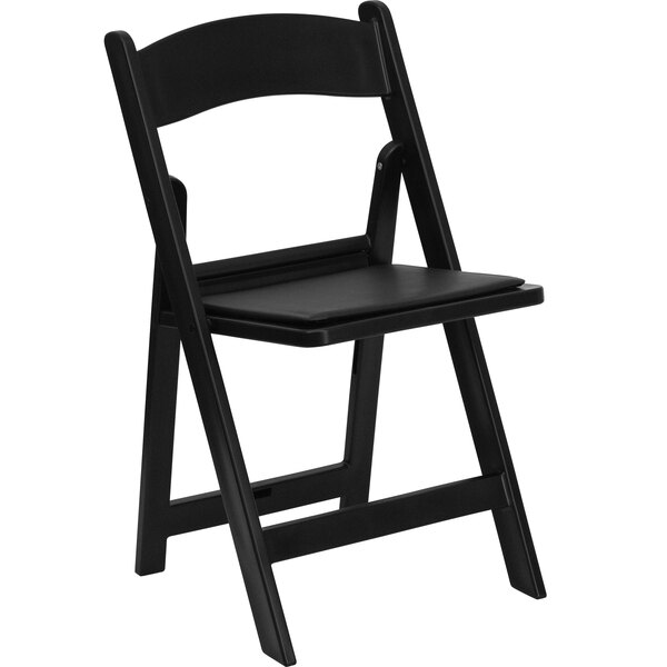 A black Flash Furniture plastic folding chair with a black padded seat.