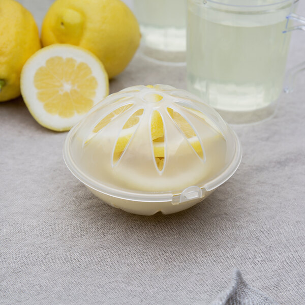 A Choice beverage dispenser fruit infuser ball with a lemon slice inside.