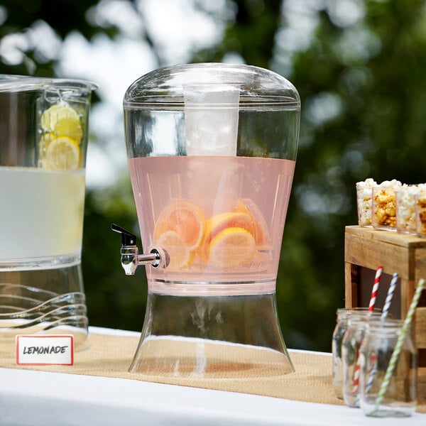 A Choice acrylic beverage dispenser filled with water, lemons, and oranges.