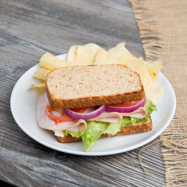 A sandwich with lettuce and tomato on a plate.