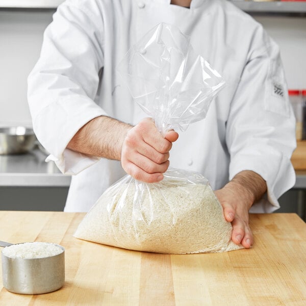 A chef holding a LK Packaging plastic food bag filled with rice.