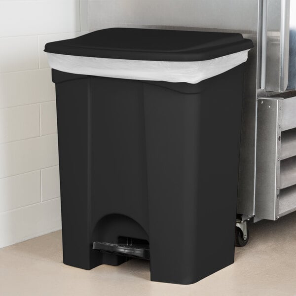 A Lavex black rectangular step-on trash can with a lid on it.