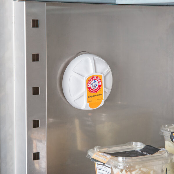 An Arm & Hammer Fridge Fresh refrigerator air filter on a refrigerator door in a kitchen.
