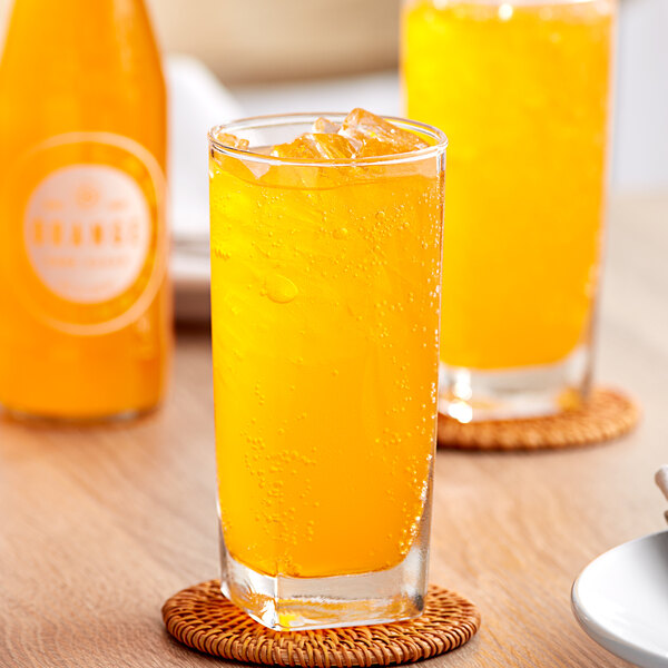 A glass of Boylan Bottling Co. orange soda on a table.