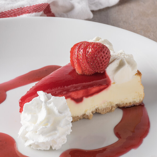 A slice of Pellman Strawberries 'N Cream Cheesecake with whipped cream and strawberries on top.