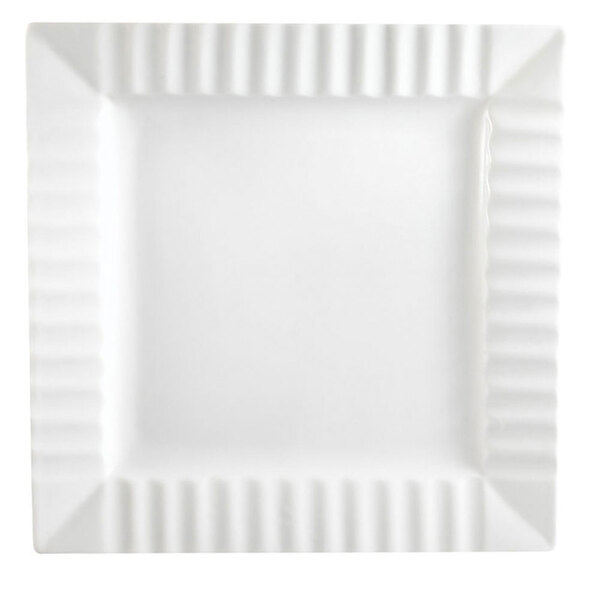 A white square porcelain plate with a wavy edge.