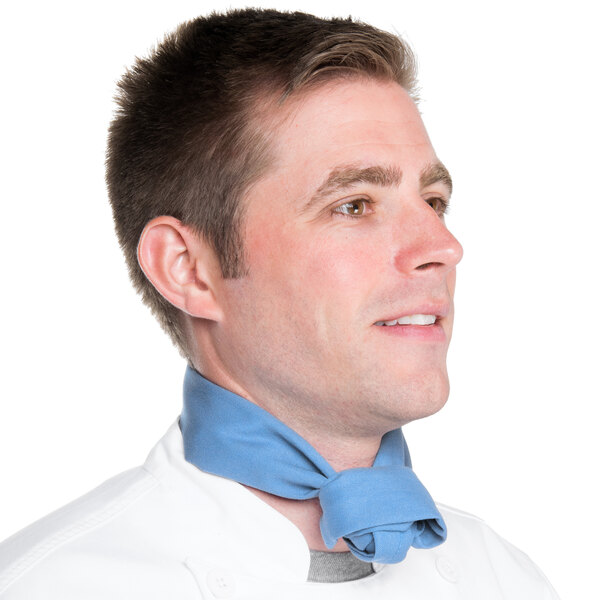 A man wearing a light blue chef neckerchief.