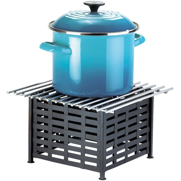 A blue pot with a lid on a metal rack.