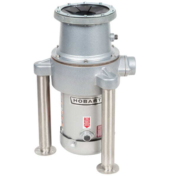 A grey Hobart commercial garbage disposer with metal flanged feet.