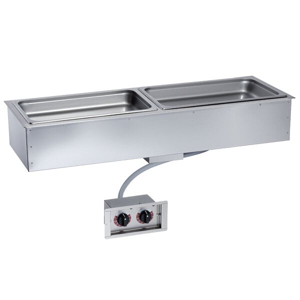 An Alto-Shaam drop-in hot food well with two stainless steel food pans on a counter.