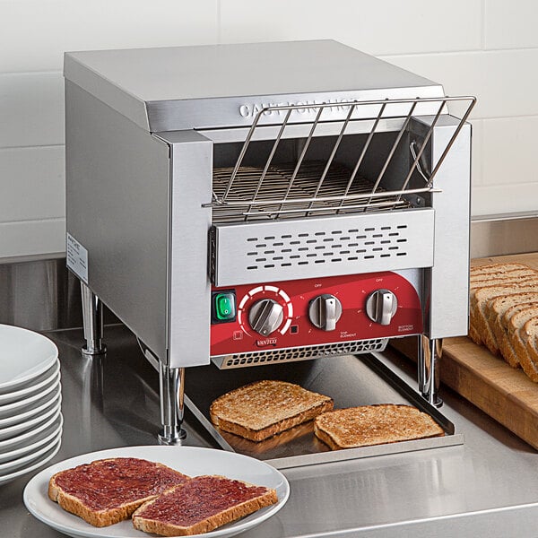 An Avantco commercial conveyor toaster with toast on a plate.