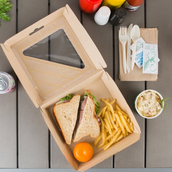 A sandwich and fries in a Bagcraft Eco-Flute take-out box with a window.