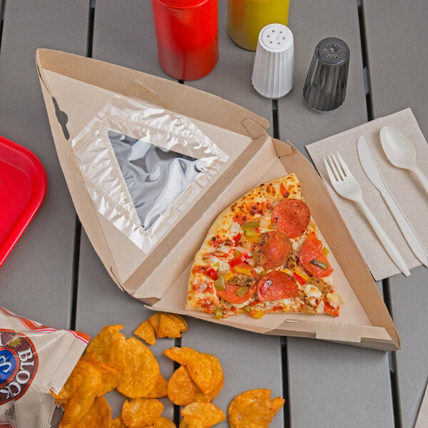 A Bagcraft corrugated pizza box with a slice of pizza and a fork on a table.