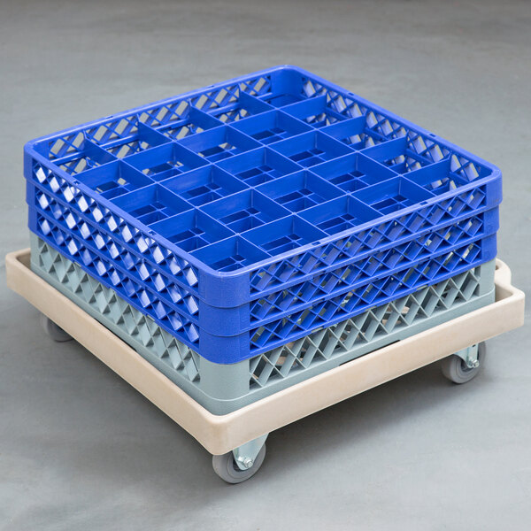 A Vollrath tan plastic rack dolly base with wheels.