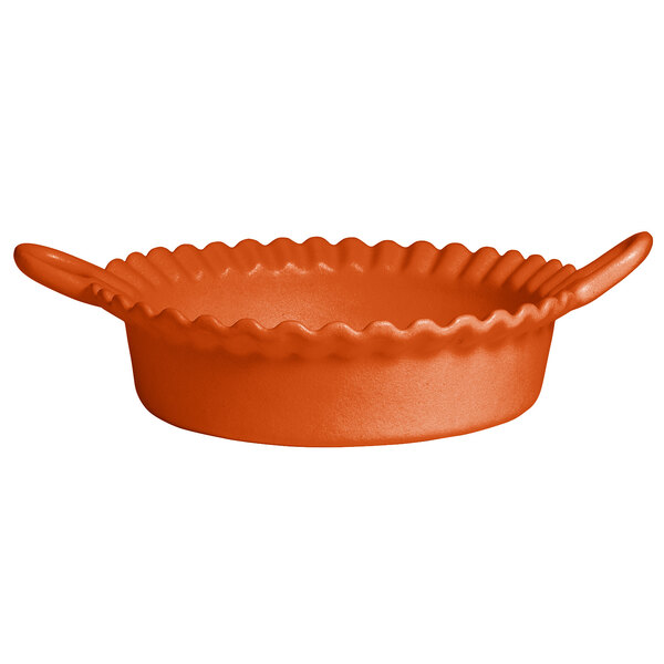 An orange deep round bowl with a wavy edge.
