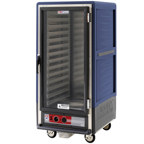 A blue and silver Metro C5 heated holding cabinet with a clear glass door on wheels.