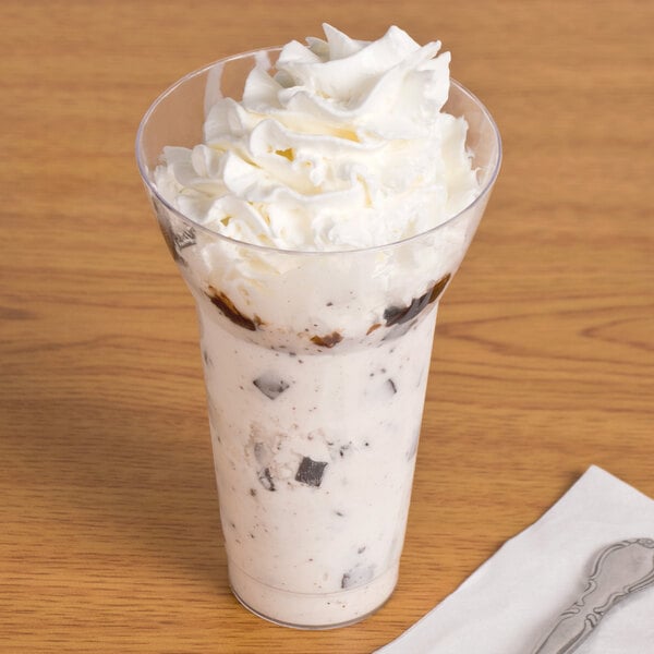 A WNA Comet Classic Crystal parfait cup filled with ice cream and topped with whipped cream.