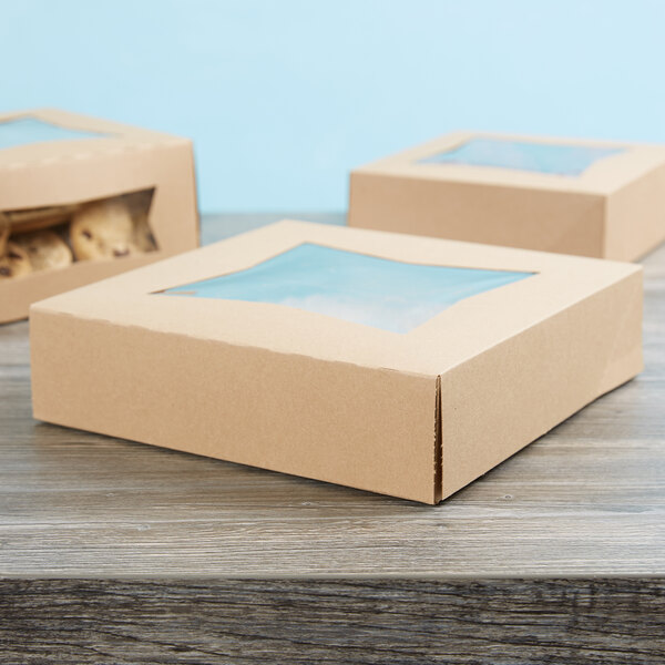 Three Kraft bakery boxes with a window, each filled with cookies.